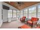 Relaxing sunroom featuring a ceiling fan, wood ceiling, and lots of windows with comfortable wicker furniture at 232 Vinewood Pl, Holly Springs, NC 27540