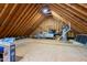 Spacious unfinished attic with exposed wooden beams, showcasing potential for storage or customization at 2404 Gillingham Dr, Apex, NC 27539