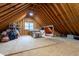 Unfinished attic with natural light, revealing exposed beams and ample space for future expansion or storage at 2404 Gillingham Dr, Apex, NC 27539