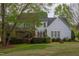 Picturesque backyard showcasing a home with a deck, screened-in porch, and well-manicured landscaping at 2404 Gillingham Dr, Apex, NC 27539