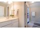 Clean bathroom featuring a single vanity, neutral walls and gold fixtures at 2404 Gillingham Dr, Apex, NC 27539