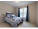 Bedroom with a queen bed, blue bedding, and natural light from the window at 2404 Gillingham Dr, Apex, NC 27539