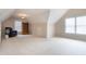 Large bonus room with neutral walls, large windows, and sloped ceilings at 2404 Gillingham Dr, Apex, NC 27539