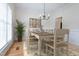 Light and bright dining room with hardwood floors, stylish chandelier, and neutral decor at 2404 Gillingham Dr, Apex, NC 27539