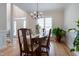 Bright dining room featuring hardwood floors, a chandelier, and large windows at 2404 Gillingham Dr, Apex, NC 27539