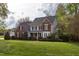 Charming two-story home with a brick and siding facade, manicured lawn, and inviting front porch at 2404 Gillingham Dr, Apex, NC 27539