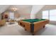 Spacious game room featuring a pool table, plush seating, and natural light, perfect for entertainment and relaxation at 2404 Gillingham Dr, Apex, NC 27539