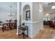 Elegant hallway with hardwood floors, decorative niche, and views into the dining room at 2404 Gillingham Dr, Apex, NC 27539