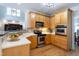 Well-equipped kitchen with stainless steel appliances and light wood cabinetry at 2404 Gillingham Dr, Apex, NC 27539