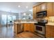 Well-lit kitchen featuring stainless steel appliances, plenty of countertop space, and hardwood floors at 2404 Gillingham Dr, Apex, NC 27539