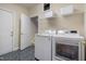 Laundry room featuring a washer, dryer, and storage shelves at 2404 Gillingham Dr, Apex, NC 27539