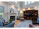 Cozy living room with a fireplace, built-in shelving, and plenty of natural light at 2404 Gillingham Dr, Apex, NC 27539