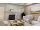 Inviting living room featuring a cozy fireplace, comfortable seating, and natural light at 2404 Gillingham Dr, Apex, NC 27539