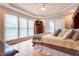 Spacious main bedroom featuring tray ceiling, large windows and hardwood floors at 2404 Gillingham Dr, Apex, NC 27539