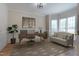 Well-lit home office with a modern desk, comfortable seating, and large windows at 2404 Gillingham Dr, Apex, NC 27539