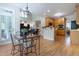 Open concept living room and kitchen dining area with hardwood floors and neutral walls at 2404 Gillingham Dr, Apex, NC 27539