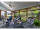Relaxing screened-in porch offers scenic outdoor views and a charming space for dining and entertaining at 2404 Gillingham Dr, Apex, NC 27539
