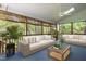 Inviting screened porch with comfortable seating and natural views, perfect for relaxing and enjoying the outdoors at 2404 Gillingham Dr, Apex, NC 27539