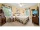 Cozy bedroom with yellow walls, floral curtains, and comfortable furnishings at 2415 Alpine Rd, Durham, NC 27707