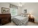 Inviting bedroom with a patterned bedspread, wooden furniture, and natural light at 2415 Alpine Rd, Durham, NC 27707