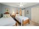 Bright bedroom with twin beds, hardwood furniture, and a view to the hallway at 2415 Alpine Rd, Durham, NC 27707