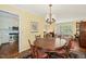 Open dining area showcasing hardwood floors, a round table, and natural light at 2415 Alpine Rd, Durham, NC 27707