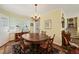 Elegant dining room with a chandelier, classic furniture, and hardwood floors at 2415 Alpine Rd, Durham, NC 27707