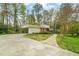 View of the home exterior featuring attached carport, manicured lawn, and stone walkway to the front door at 2415 Alpine Rd, Durham, NC 27707
