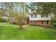 Charming home exterior with brick accents, black shutters, and a well-maintained front lawn at 2415 Alpine Rd, Durham, NC 27707