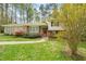 Charming two-story home with brick and vinyl siding and a well-maintained, landscaped front yard at 2415 Alpine Rd, Durham, NC 27707