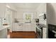 Bright, updated kitchen featuring white cabinets, subway tile backsplash, and stainless steel appliances at 2415 Alpine Rd, Durham, NC 27707