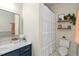 Lovely bathroom featuring a toilet, shower with curtain, and floating shelves with plants at 2651 Mellow Field Dr # 206, Raleigh, NC 27604