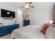 Bright bedroom featuring a large dresser, TV, and neutral walls at 2651 Mellow Field Dr # 206, Raleigh, NC 27604