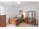 Inviting bedroom with neutral carpet, wood furniture, and an airy feel at 2651 Mellow Field Dr # 206, Raleigh, NC 27604