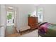 Well-lit bedroom features neutral carpet, a dresser, and view into the hallway at 2651 Mellow Field Dr # 206, Raleigh, NC 27604