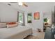 Well-lit bedroom featuring a ceiling fan, two large windows, and view into the living room at 2651 Mellow Field Dr # 206, Raleigh, NC 27604