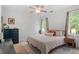 Serene bedroom with a ceiling fan, bedside tables, and two windows at 2651 Mellow Field Dr # 206, Raleigh, NC 27604