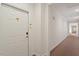 Clean, carpeted hallway featuring a white unit door at 2651 Mellow Field Dr # 206, Raleigh, NC 27604