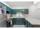 Updated kitchen with stainless steel appliances, ample counter space, and green cabinetry at 2651 Mellow Field Dr # 206, Raleigh, NC 27604