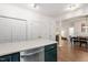 Modern kitchen with green cabinets is adjacent to the dining and living areas at 2651 Mellow Field Dr # 206, Raleigh, NC 27604