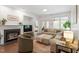 Cozy living room boasts fireplace, neutral decor, and access to a balcony at 2651 Mellow Field Dr # 206, Raleigh, NC 27604