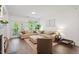 Bright living room featuring hardwood floors, a large sofa, and access to the outdoors at 2651 Mellow Field Dr # 206, Raleigh, NC 27604