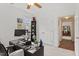 Bright home office features large windows, neutral carpet, and view into the hallway at 2651 Mellow Field Dr # 206, Raleigh, NC 27604