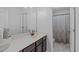 Bathroom features a large mirror, vanity with storage, and walk-in shower at 2705 Evanston Ave, Durham, NC 27703