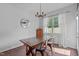 Bright dining room with wood table, accent mirror, and modern chandelier at 2705 Evanston Ave, Durham, NC 27703