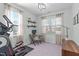 Bright home office with desk, dual windows, and exercise equipment at 2705 Evanston Ave, Durham, NC 27703