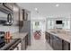 Bright kitchen featuring granite countertops, stainless steel appliances, and tile flooring at 2705 Evanston Ave, Durham, NC 27703