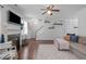 Living room featuring a fireplace, TV, and staircase leading to the second floor at 2705 Evanston Ave, Durham, NC 27703