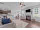 Open-concept living room featuring a fireplace, TV, and open view of the kitchen and dining room at 2705 Evanston Ave, Durham, NC 27703