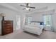 Bedroom featuring a tray ceiling, ceiling fan, carpet floors and ensuite bath at 2705 Evanston Ave, Durham, NC 27703